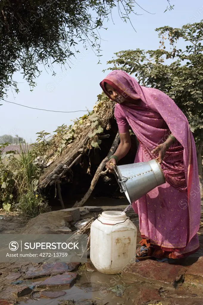 India, Rajasthan, Rohet.  Without running water in their homes, the village well and water pump become a meeting point for the women of the communities.