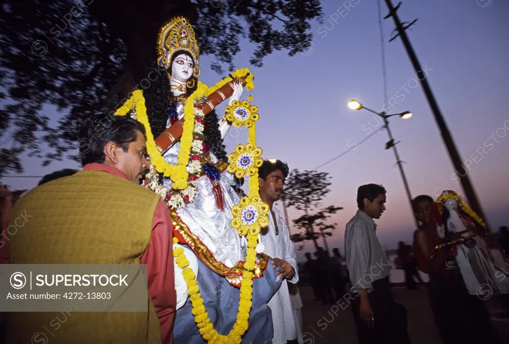 Devotees carrying an effigy of the Goddess Saraswati to the Hoogly River on the day of the Saraswati Festival. Saraswati is regarded as the Goddess of learning, knowledge and the arts. Goddess Saraswati is the wife  of Lord Brahma and possesses the powers of speech, wisdom and learning.