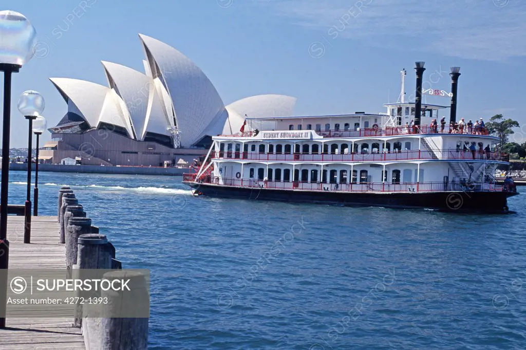 Australia, Sydney. A showboat cruises into Sydney Harbour with the Opera House in the background