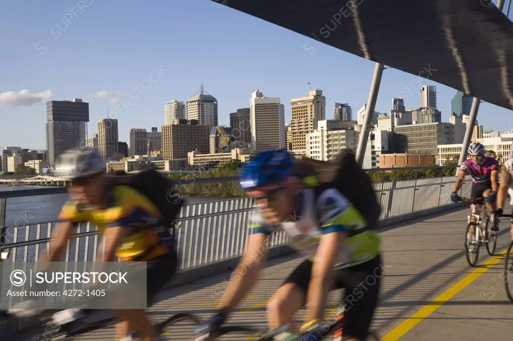 Australia, Queensland, Brisbane. Cyclists cross the newly built Goodwill Bridge connecting the central business district with the South Bank Parklands in Brisbane.