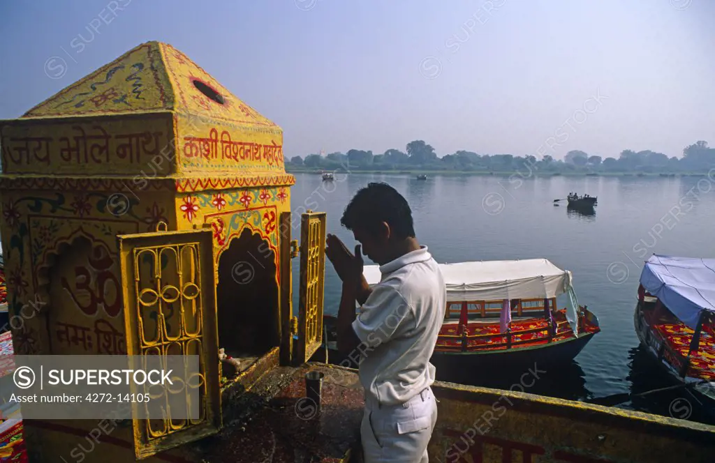 India, Uttar Pradesh, Mathura. A pilgrim prays beside the Yamuna River near Vishram Ghat, part of the Lord Krishna's 'holy circuit.'