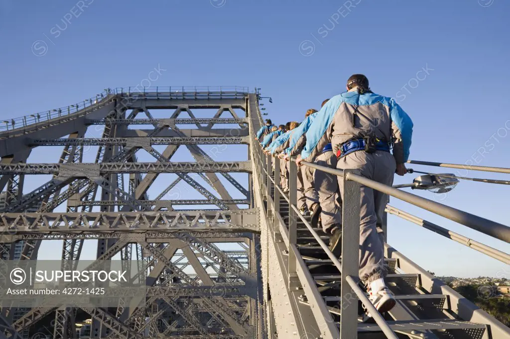 Australia, Queensland, Brisbane. A group of climbers make their way up the steel girders of Brisbane's Story Bridge.  The Story Bridge Adventure Climb commenced in 2005 and is one of only four such experiences in the world.