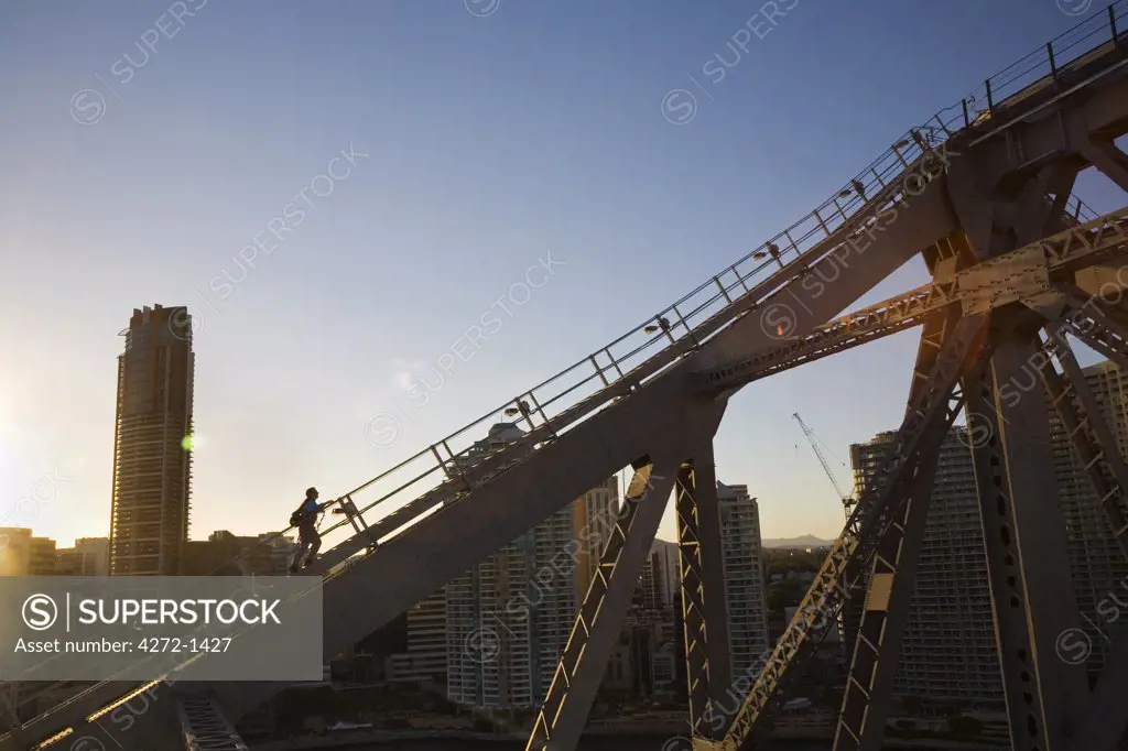 Australia, Queensland, Brisbane. A climber traverses the steel girders of the Story Bridge in Brisbane.  The Story Bridge Adventure Climb opened in 2005 and allows visitors to experience an ascent of Brisbane's iconic bridge.