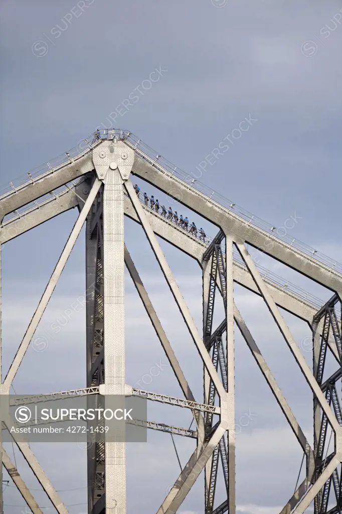 Australia, Queensland, Brisbane. Climbers traverse the steel girders of the Story Bridge in Brisbane.  The Story Bridge Adventure Climb on Brisbane's iconic structure is one of only four such experiences in the world.