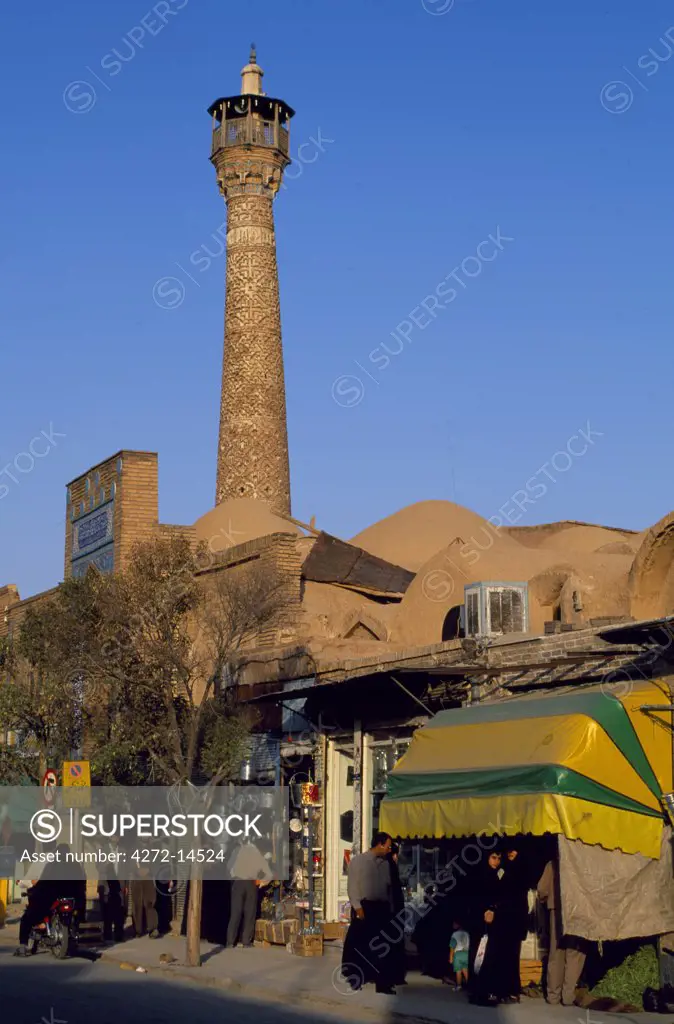 Masjed e Jame minaret and bazaar, Semnan, Semnan Province, Iran.  Seljuk period, first half of 11th century.  The Masjed e Jame, Friday mosque, is in the heart of the bazaar. Further evidence of the way in which, for people of the Silk Road, faith and commerce were frequently intertwined.