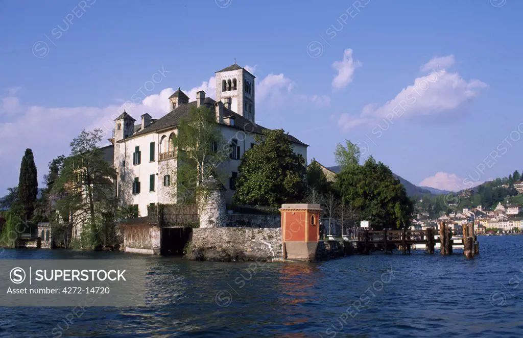 View of the Basilica on Isola San Giulio from Taxi boat with town of Orta san Giulio in the background.