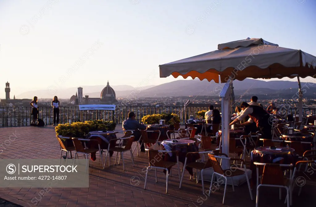 Cafe at Piazzale Michelangelo overlooking Florence at sunset with The Duomo in the background.
