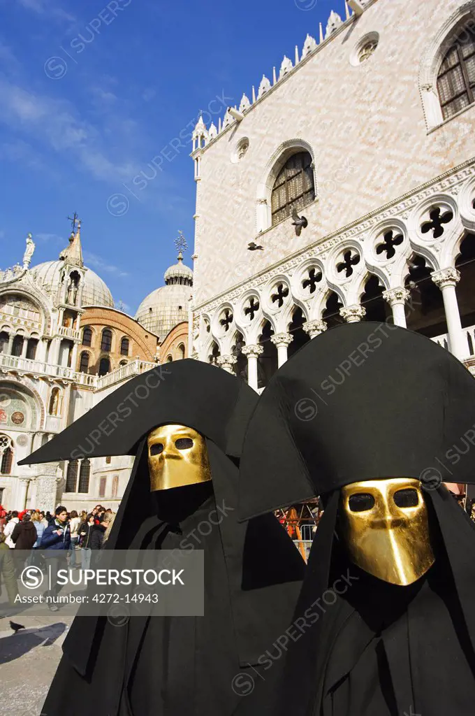 Venice Carnival People in Costumes and Masks outside St Marks Cathedral.