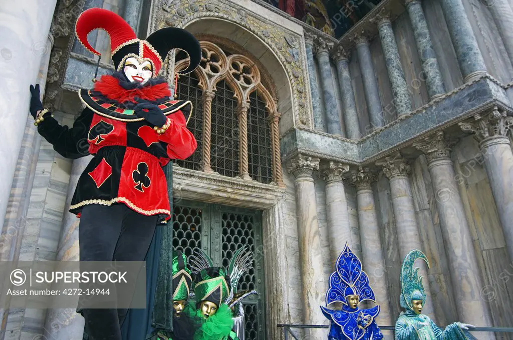 Venice Carnival Joker Costumes and Mask infront of St Marks Cathedral.