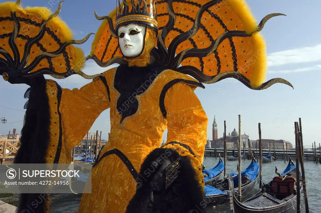 Italy Veneto Venice Venice Carnival People in Costumes and Masks on Canal with Gondolas and Isola Di San Giorgio Maggiore.