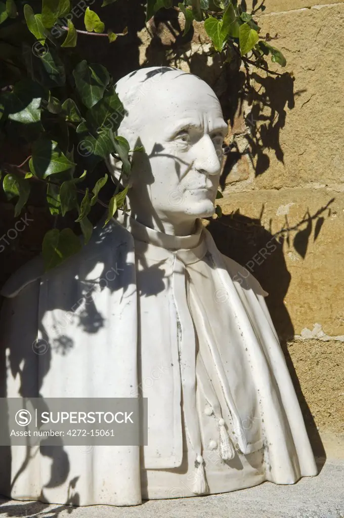 Italy, Tuscany, Montepulciano. Bust of a Catholic cardinal decorates one of Montepulciano's medieval streets.