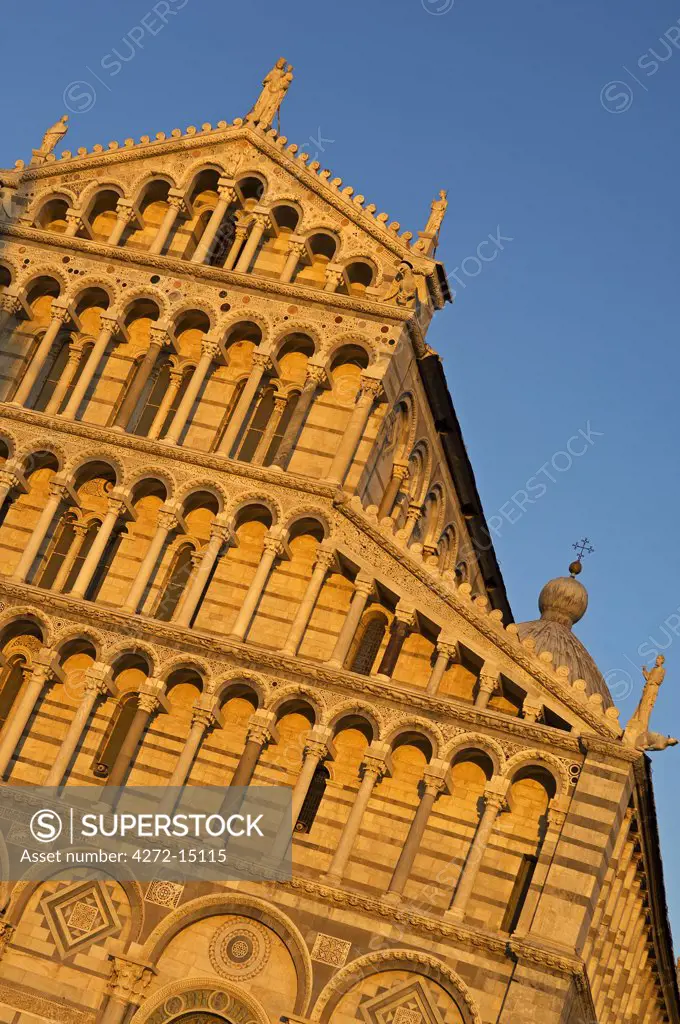 Italy, Tuscany, Pisa. Detail of the ornately carved marble columns and statues on the facade of the 12th Century Duomo in the Piazza dei Miracoli (Square of Miracles).