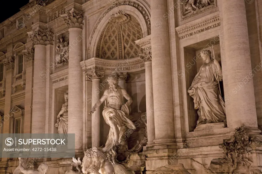 Rome, Italy; Detail of the Fontana di Trevi in the last evening light with the mighty figure of Oceanus, the god of the ocean on a shell shaped chariot in the middle with the stautes of abundance and healing left and right respectively