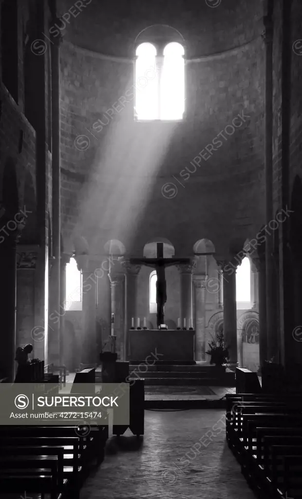 Prayer in Sant' Antimo Abbey near Montalcino, Valle de Orcia, Tuscany, Italy