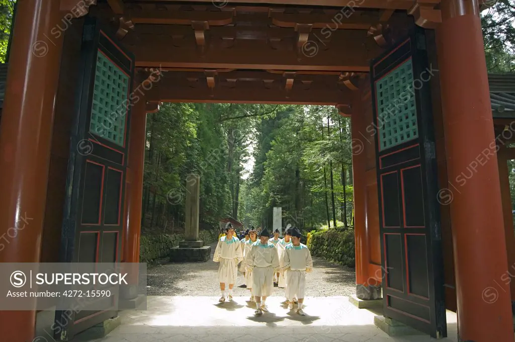 Spring Festival priests walking through gate of Futarasan Shrine