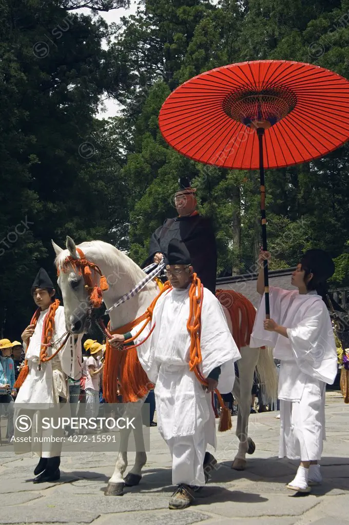 Spring Festival Toshogu shrine Tokugawa dynasty men in traditional costume on horse carrying red parasol