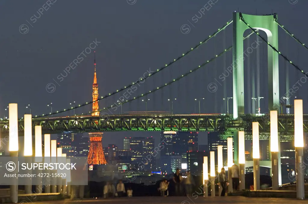Rainbow Bridge and Tokyo Tower, people in the foreground taking an evening stroll.