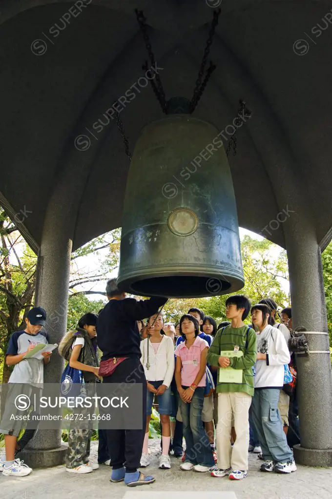 Japan, Honshu Island, Hiroshima Prefecture, Hiroshima City, Hiroshima Peace Memorial Park. Students being educated about WWII and the Peace Bell.