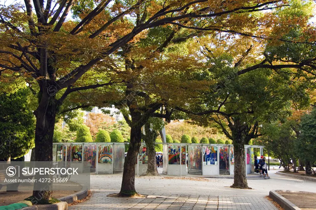 Japan, Honshu Island, Hiroshima Prefecture, Hiroshima City, Hiroshima Peace Memorial Park. Children's Peace Monument - Origami Cranes on display under the autumn trees.