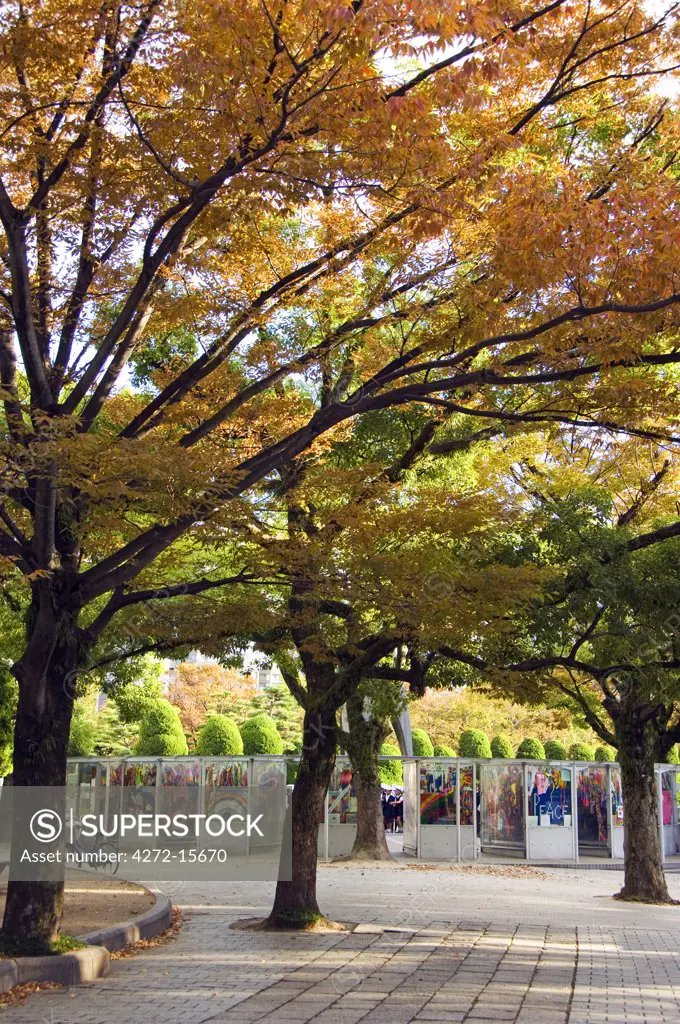 Japan, Honshu Island, Hiroshima Prefecture, Hiroshima City, Hiroshima Peace Memorial Park. Children's Peace Monument - Origami Cranes on display under the autumn trees.