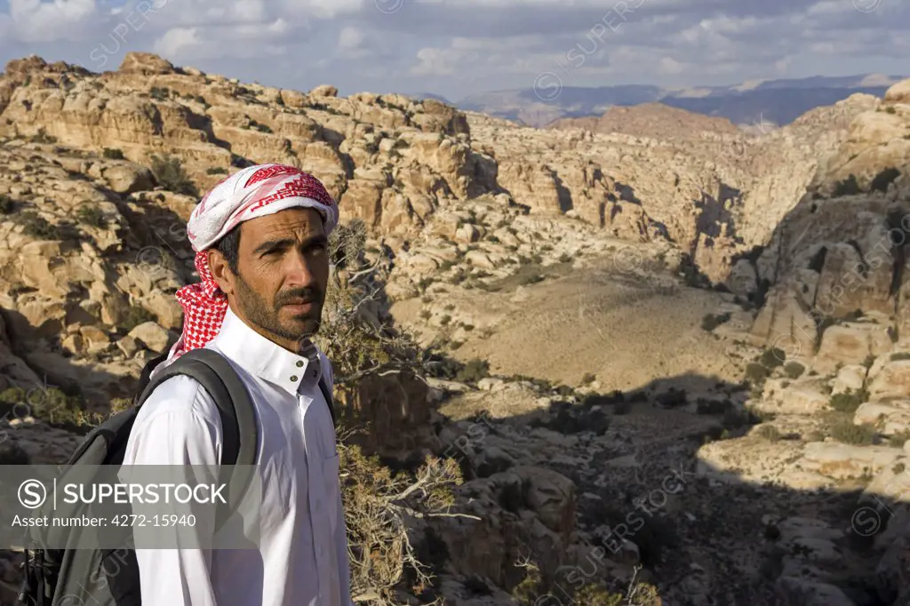 Jordan, Petra Region. Trekking the ancient trading route from the Nabeatean capital of Petra through the Shara Mountains towards the Dead Sea a local Beduin guide leads the way. (MR)