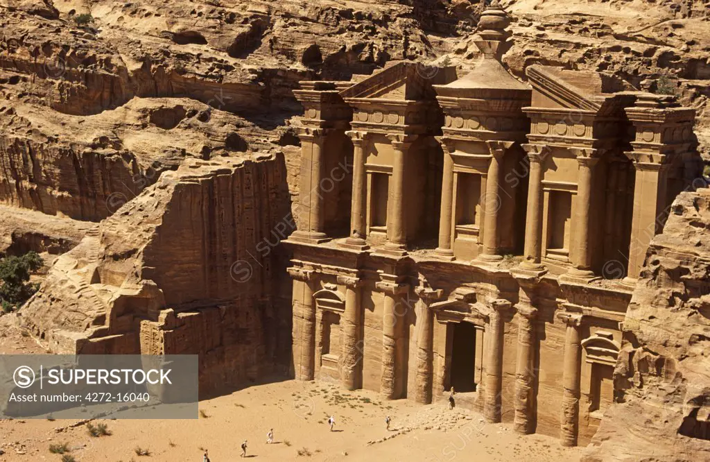 Jordan, Petra. Tourists approach the imposing facade of its famous so-called Monastery deep in the rugged hills above the heart of this fabled Nabatean city.