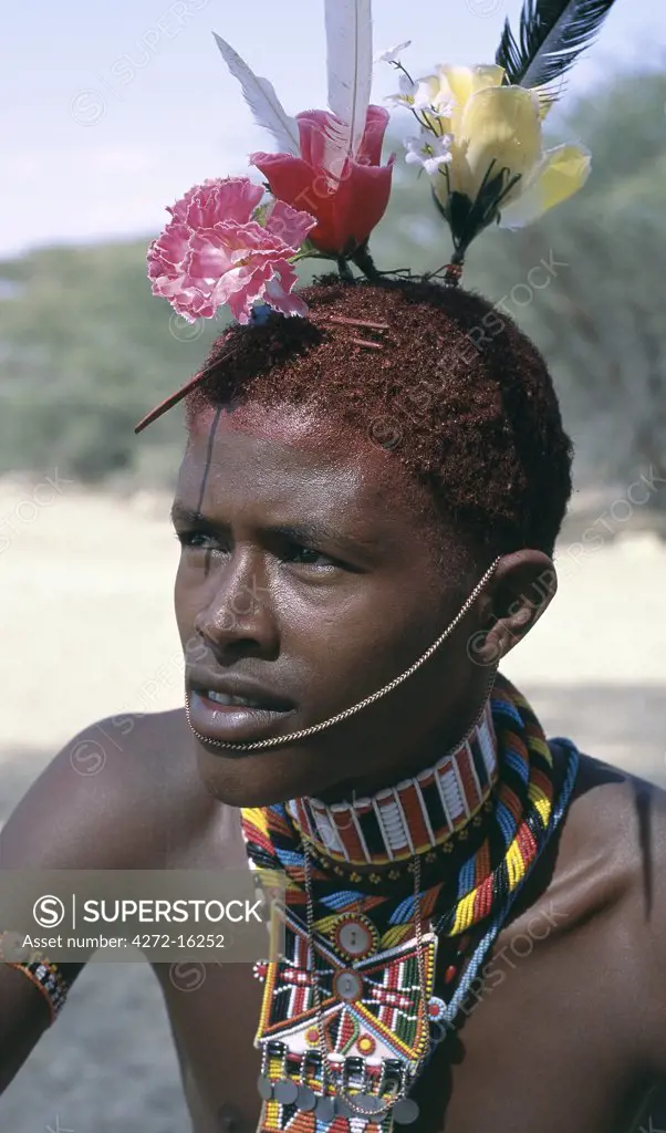 The adornments of Samburu warriors change from generation to generation.  In the 1990's cheap plastic flowers from China became fashionable.