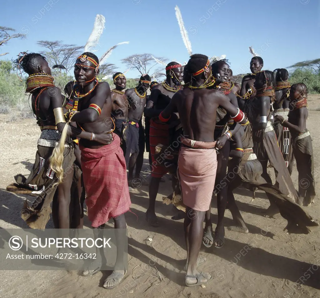 Song is an art form ingrained in Turkana culture.  In this picture, young men and girls are performing the naleyo, the only dance among a repertoire of more than twenty where couples dance together.  The songs narrate love stories about small animals such as tortoises, hares, squirrels and dikdiks.