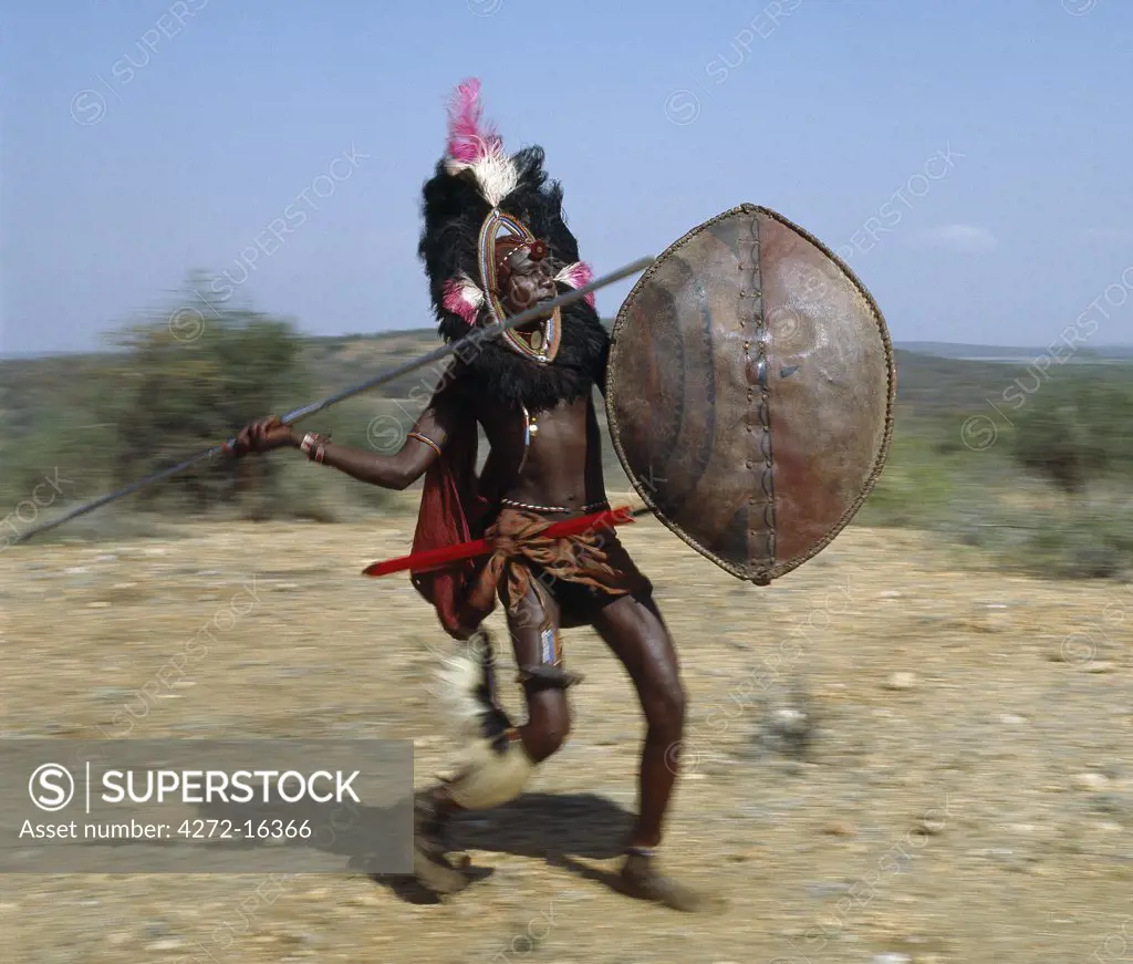 A Maasai warrior in full battle cry, his long-bladed spear at the ready.