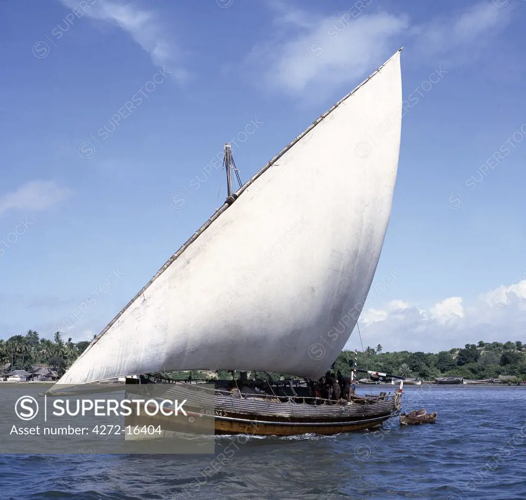 Kenya, Lamu Island, Lamu . A jahazi  or small dhow (the wooden sailing boats of the region) sets sail from Lamu Island.