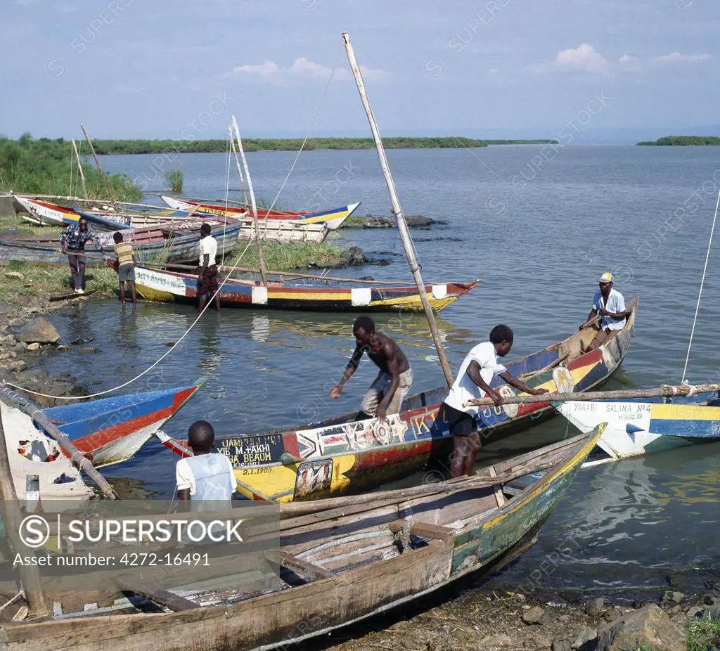 Brightly painted fishing boats of the Luo people find safe harbour on Lake Victoria at Dunga Beach near Kisumu. The fishermen catch tilapia, nile perch and a small sardine like fish  called omena (Stolothrissa tanganicae), which is sun-dried before being taken to market.