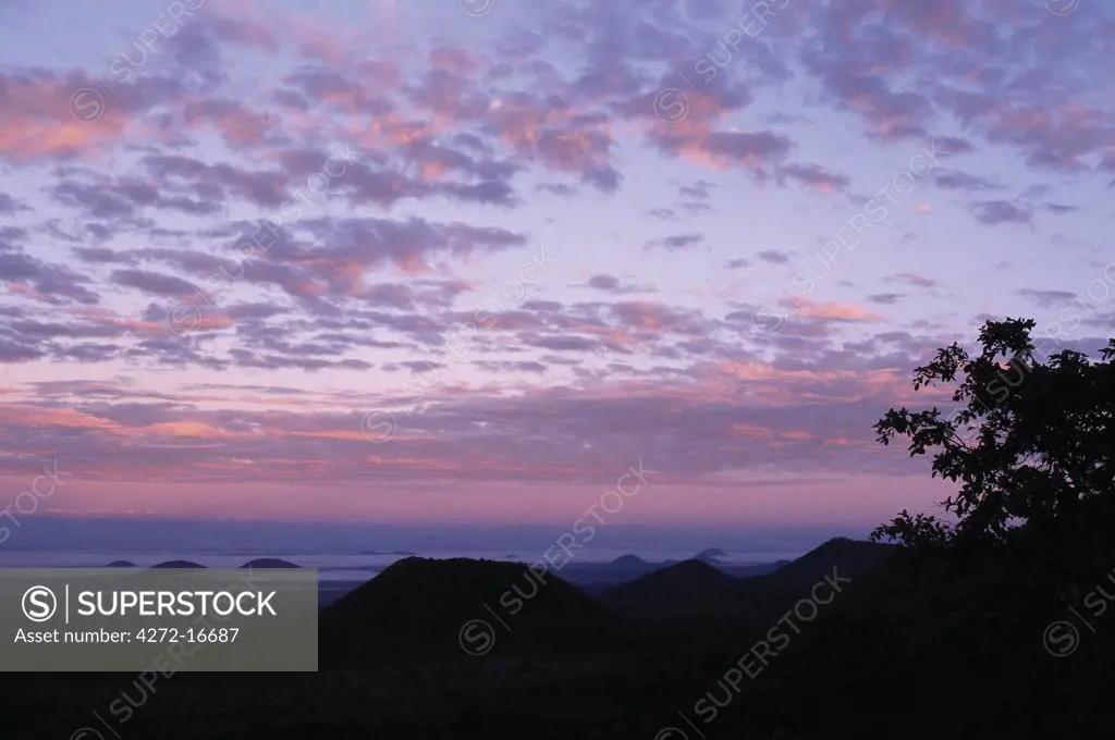 At daybreak, cone-shaped hills accentuated by ground mist dot the foothills of the 7,000-foot-high Chyulu Hills. This beautiful range is of relatively young volcanic origin.