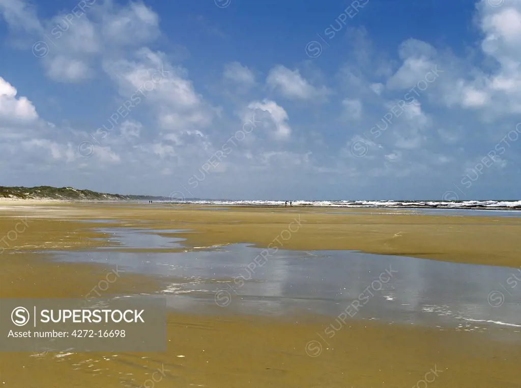 An unspoiled beach just south of the Tana Delta where Kenya's largest river enters the Indian Ocean.  The reddish colour of the sand is caused by river silt entering the sea.