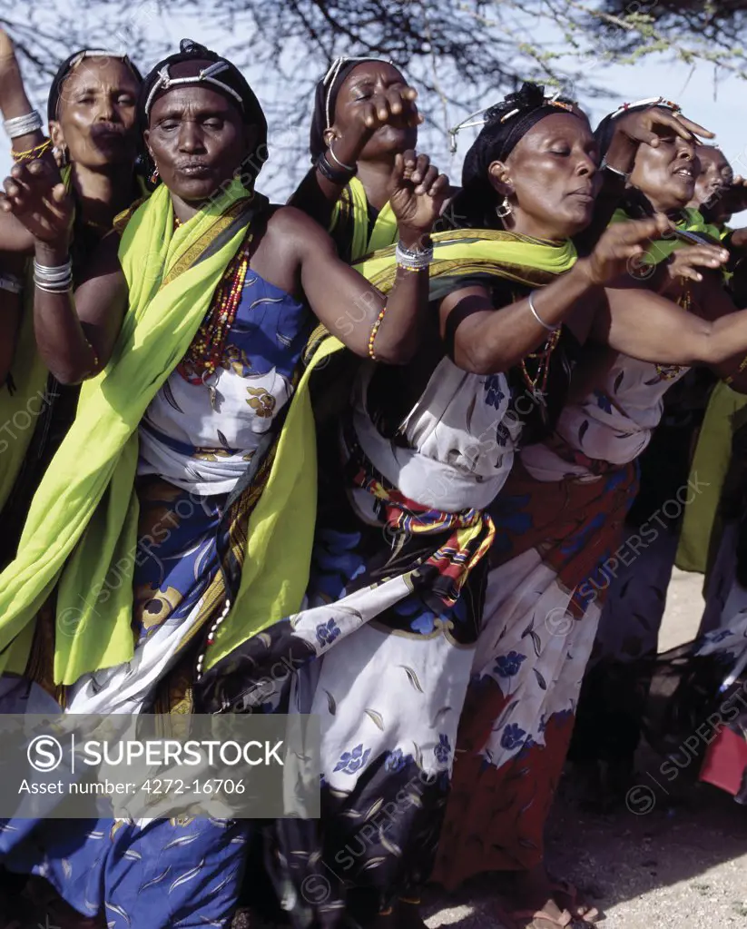 Gabbra women sing and dance to celebrate a wedding.  The traditional metal ornamentation on their heads is called malmal.