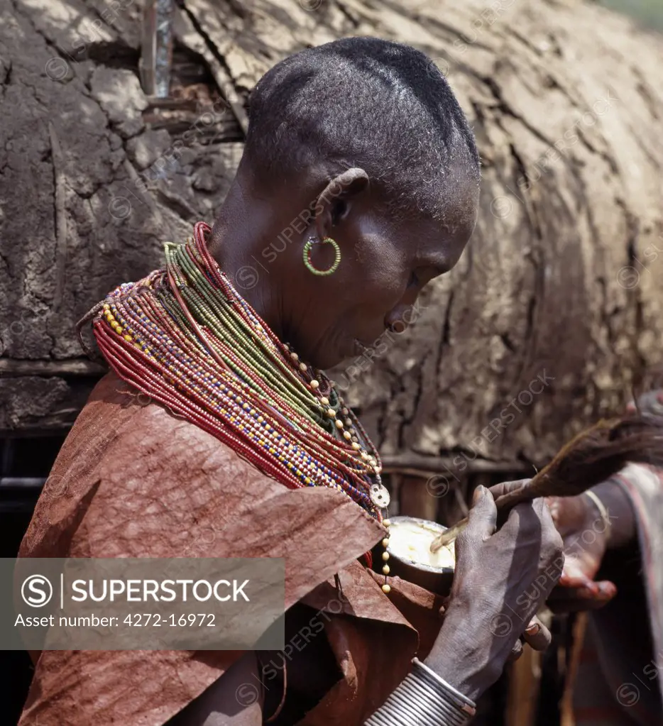 The day after a Samburu boy has been circumcised, a 'Firestick elder' _ one of the elders responsible for the ceremonial proceedings at the circumcision ceremony and for disciplining the new warrior generation _ will smear his forehead and hair with butter fat from a wooden jar held by his wife.