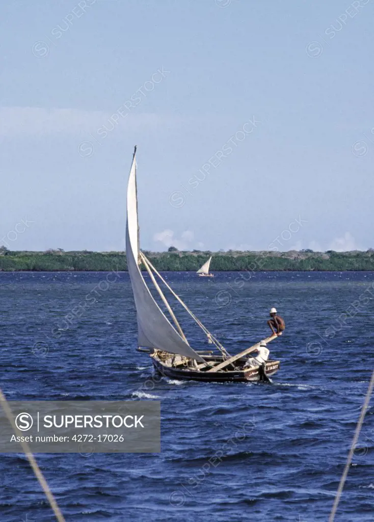A small wooden sailing boat with an outrigger off Lamu Island.