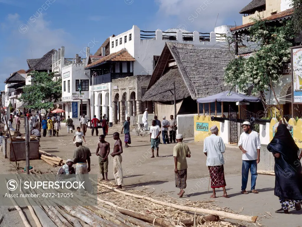 A typical bustling scene along the waterfront of Lamu Island. The majority of people on the island practice a fairly relaxed form of Islam, hence the black clothes and face veils of women and the white khanzus or coloured kikois and embroidered hats of the men.