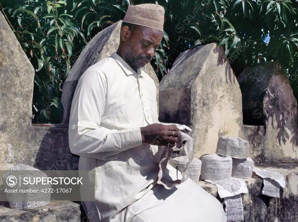 A man embroiders Swahili hats, which are popular with Muslims on Lamu Island and elsewhere.   It takes hours of patience and great skill to make a really fine hat. Situated 150 miles north northeast of Mombasa, Lamu town dates from the 15th century AD.