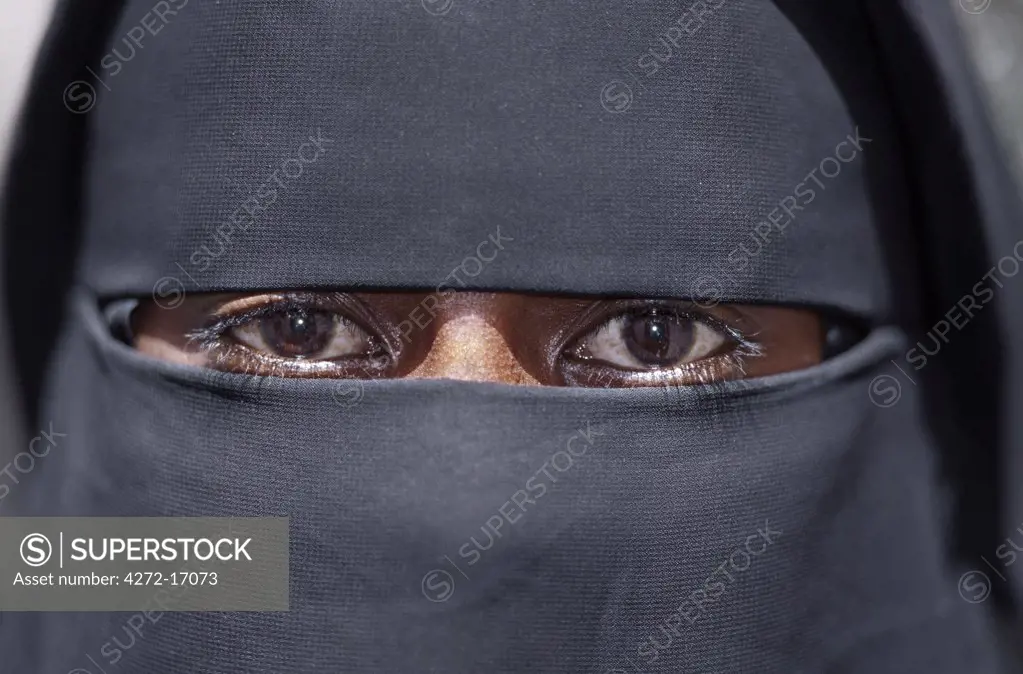 The eyes of a Lamu woman wearing a traditional black Islamic dress and face veil. Situated 150 miles north northeast of Mombasa, Lamu town dates from the 15th century AD.