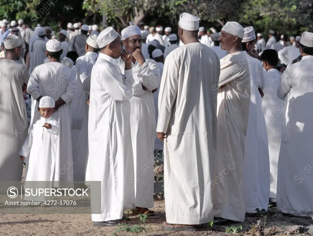 On a late Friday afternoon, Lamu men and boys in traditional Islamic dress gather to pray at Lamus Islamic graveyard before setting out in procession to celebrate Maulidi, the Prophet Mohameds birthday. This is a major event in Lamu and attracts pilgrims from all over East Africa and sometimes farther afield.
