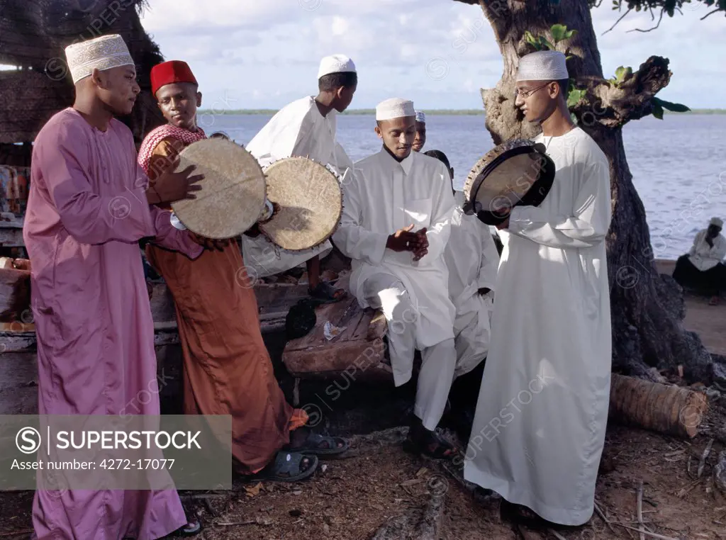On a late Friday afternoon, Lamu men and boys in traditional Islamic dress sing before joining a procession to celebrate Maulidi, the Prophet Mohameds birthday. Tambourines are played in mosques on the island but they are seldom used in Islamic culture elsewhere.  Maulidi is a major event in Lamu attracting pilgrims from all over East Africa and sometimes farther afield.