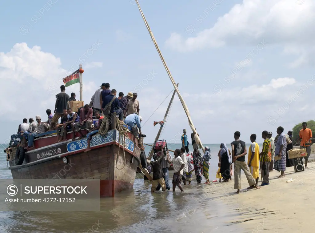 A ferry picks up passengers and freight from the beach at Mtangawanda on Pate Island.  This motorized wooden boat is the principal means of transport between Lamu and Pate Island.