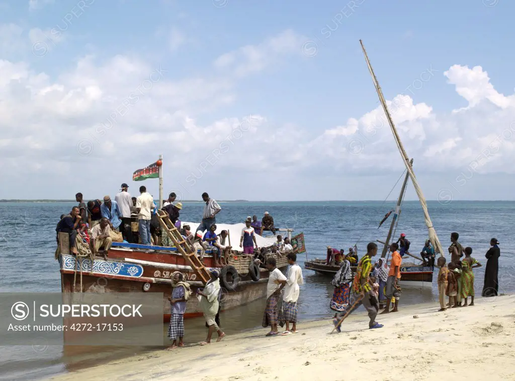 A ferry picks up passengers and freight from the beach at Mtangawanda on Pate Island.  This motorized wooden boat is the principal means of transport between Lamu and Pate Island.