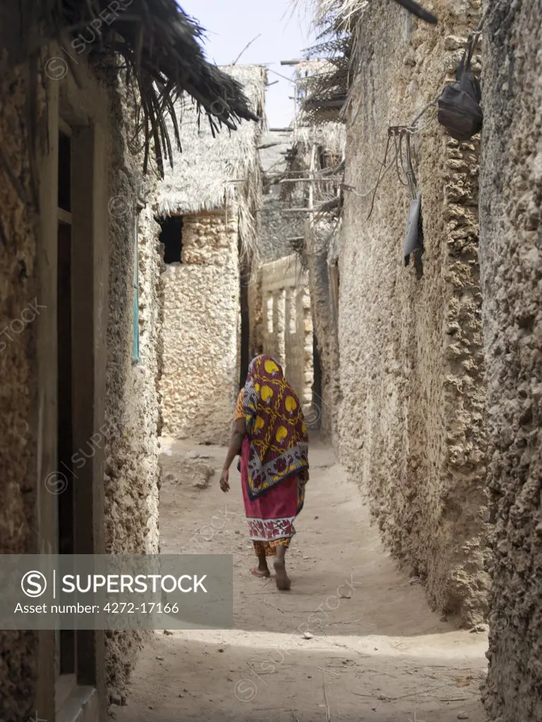 A typical street scene in one of the poorer areas of Pate Village. All the buildings in Pate are constructed of coral rag with makuti roofs, which are a type of thatch made from coconut palm fronds. Pate was established by Arabs from Arabia in the 13th century, or possibly earlier.