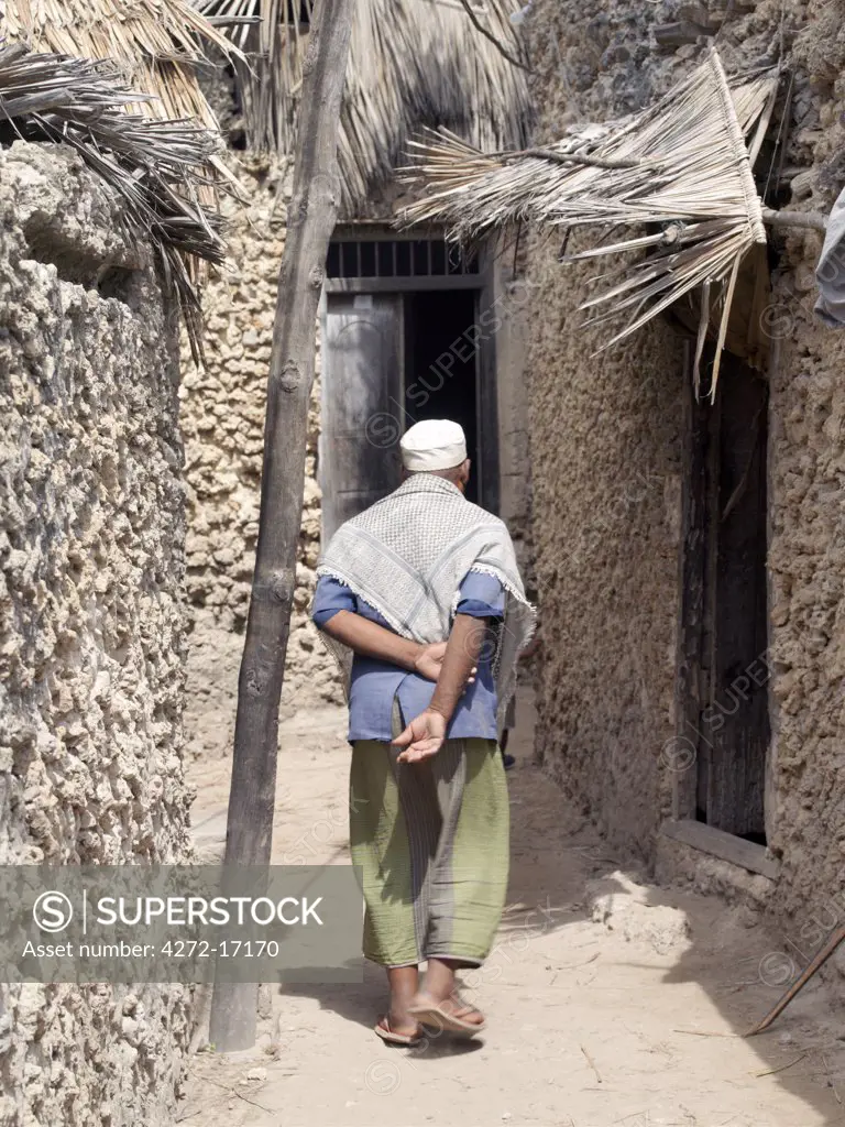 A typical street scene in Pate Village. All the buildings in Pate are constructed of coral rag with makuti roofs, which are a type of thatch made from coconut palm fronds. Pate was established by Arabs from Arabia in the 13th century, or possibly earlier.