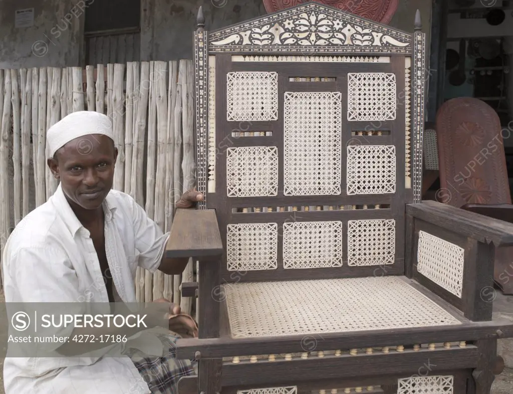 A skilled craftsman puts the finishes touches to a replica of a Pate Island chair.  Wood carving is the most important craft in Lamu and sustains the greatest number of artisans.  Fine marquetry work is another age old skill of local craftsmen. Situated 150 miles north northeast of Mombasa, Lamu town dates from the 15th century AD.