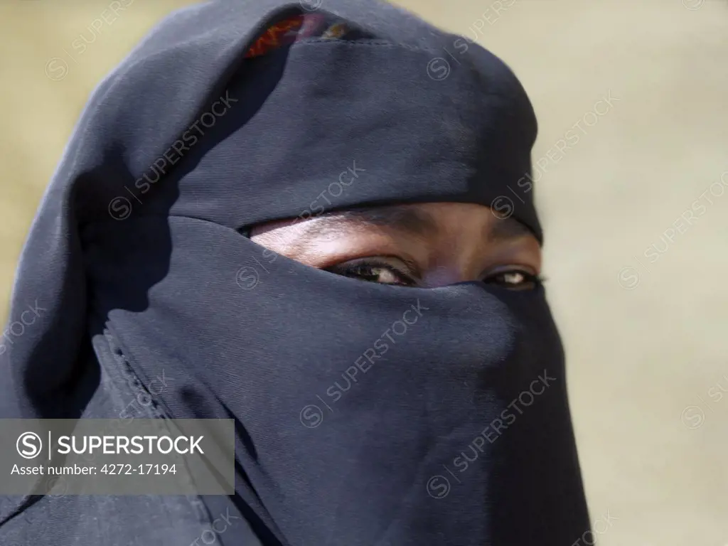 A Lamu woman wearing a traditional black Islamic dress and face veil  Situated 150 miles north-northeast of Mombasa, Lamu town dates from the 15th century AD.