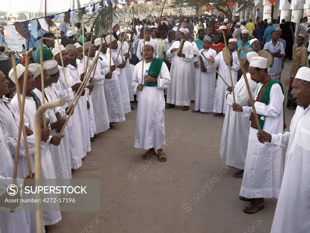 In the late afternoon, Muslim men perform the Shabuwani along the waterfront at Lamu town during the annual Lamu festival. Situated 150 miles north northeast of Mombasa, Lamu town dates from the 15th century AD.