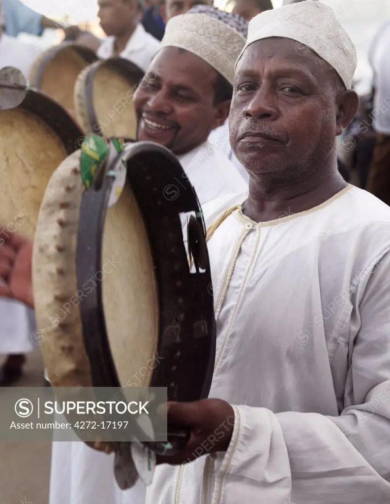 Muslim men maintain rhythm with tambourines during a performance of the Shabuwani along the waterfront at Lamu town. Situated 150 miles north northeast of Mombasa, Lamu town dates from the 15th century AD.