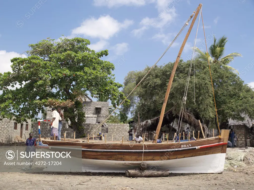 Boat builders put the finishing touches to a new jahazi in the open boatyard at Matondoni, Lamu Island. The place has been famous for making traditional wooden sailing boats for a century or more.